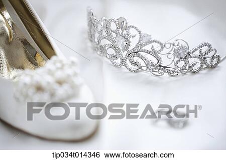 Stock Photograph - wedding rings and heels on wedding dress. Fotosearch
