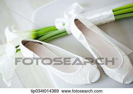 Stock Photo - white heels and flowers . Fotosearch