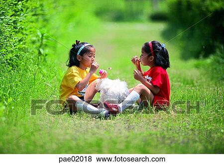 Stock Photo - child, girl, Oriental people, bubble, bubble play, friend, sister. Fotosearch