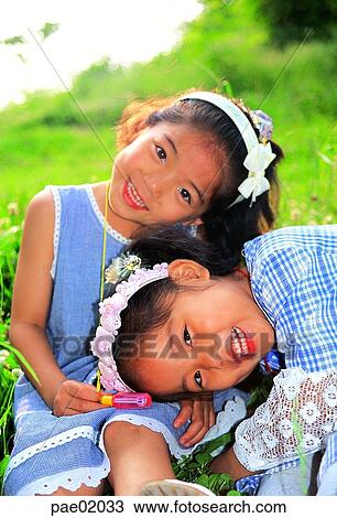 child, girllaughter, smile, sister, friend, outdoor, oriantal View Large Photo Image Stock Image - child, girllaughter, smile, sister, friend, outdoor, oriantal. Fotosearch