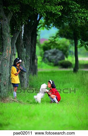 Stock Image - child, Oriental people, animal, movie, sister, friend, girl. Fotosearch
