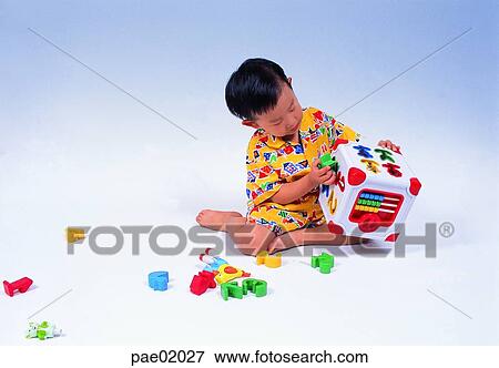 Stock Photo - child, play, toy, teaching tools, studying tools, boy, indoor. Fotosearch