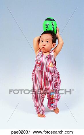 child, Rugbyball, boy, indoor, oriantal View Large Photo Image Stock Photo - child, Rugbyball, boy, indoor, oriantal. Fotosearch