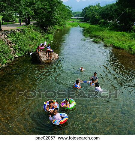 child, summer, waterways, ditch, stream water, tube, human View Large Photo Image Stock Photo - child, summer, waterways, ditch, stream water, tube, human. Fotosearch