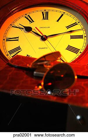 Stock Image - sunglasses, time, clock, watch, indoor, sunglasses. Fotosearch