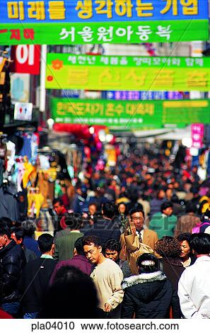 Stock Image - man and woman, men and women, male and female, Namdaemun market, day, Oriental, busy. Fotosearch
