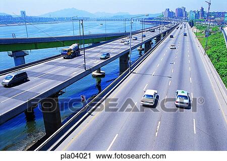 Stock Image - riverside road, riverside road, traffic, transport, transit, traffic and street, traffic and road. Fotosearch