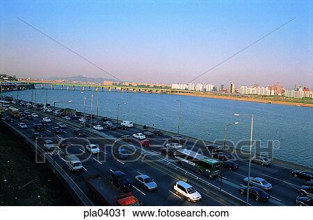 Stock Image - riverside road, riverside road, traffic, transport, transit, traffic and street, traffic and road. Fotosearch