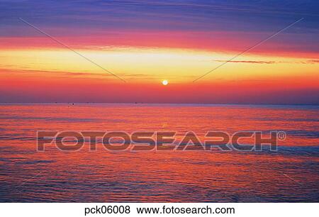 Stock Photo - cloud, red sky, sunset, sunrise, wave, surge, ripple. Fotosearch