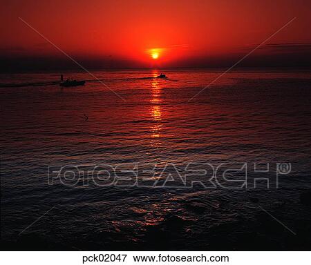 Stock Photo - cloud, return trip, return voyage, red sky, sunset, sunrise, wave. Fotosearch