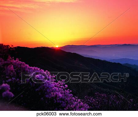 Stock Image - red sky, sunset, sunrise, ridgeline, outline, mountain. Fotosearch