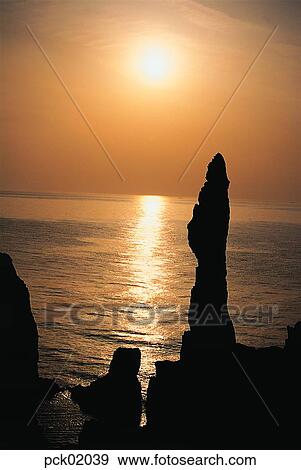 Stock Photo - red sky, sunset, sunrise, wave, surge, ripple, shadows on the water. Fotosearch