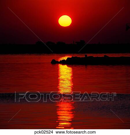 tourist, red sky, sunset, sunrise, wave, surge, ripple View Large Photo Image Picture - tourist, red sky, sunset, sunrise, wave, surge, ripple. Fotosearch