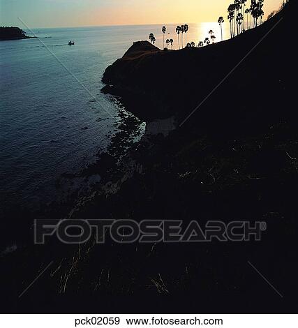 Stock Photo - tree, red sky, sunset, sunrise, wave, surge, ripple. Fotosearch