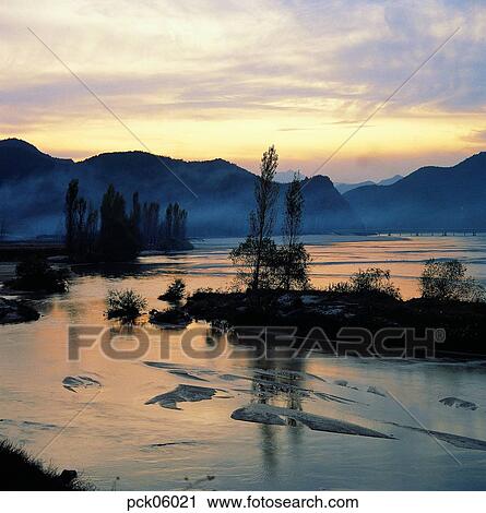 river, riverside, riverside village, calm, cloud, tree, red sky View Large Photo Image Stock Image - river, riverside, riverside village, calm, cloud, tree, red sky. Fotosearch