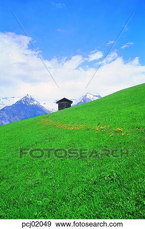 Stock Photo - spring, landscape, lawn, sky, field, hill, house. Fotosearch
