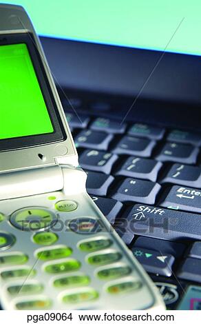 Picture - day, notebook, mobile, mobile phone, indoor, mobile telecommunications. Fotosearch