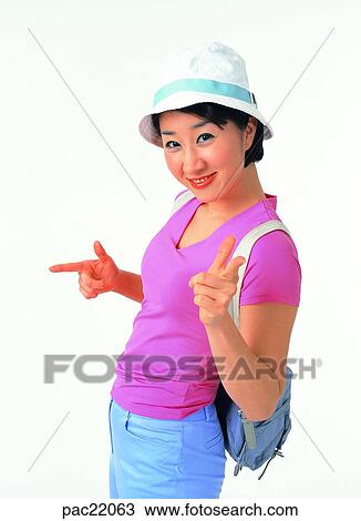 Stock Image - Oriental, model, wearing a hat, backpack, knapsack, backpack, knapsack. Fotosearch