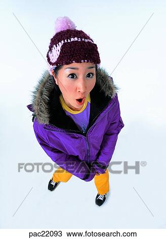 Stock Image - surprising look, shocked look, surprise, amazement, Oriental, model, wearing a hat. Fotosearch