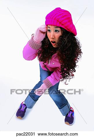 Stock Image - winter, cute, pretty, Oriental, model, wearing a hat, mitten. Fotosearch