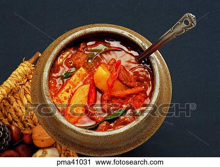 Stock Image - hot pepper sauce soup with tufu, spoon, indoor, cook, cooking, food. Fotosearch