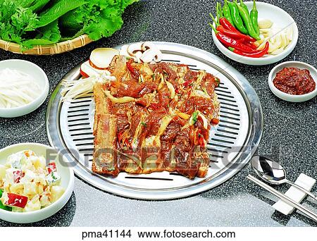 Picture - ribs without bones, meat, meat dish, pork, side dish, roasted meat or fish on the charcoal fire. Fotosearch