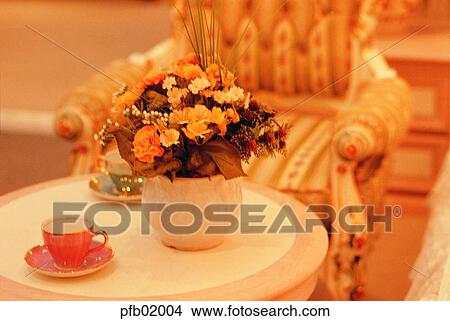 living room interior, table, flower decoration, coffee glass, chair, bench, sofa View Large Photo Image Picture - living room interior, table, flower decoration, coffee glass, chair, bench, sofa. Fotosearch