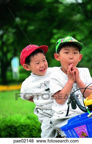 Stock Photo - children, child, kid, boy, boy, riding a bike, riding a bicycle. Fotosearch