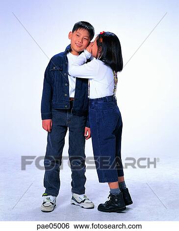 Stock Photograph - whisper, secret, brothers and sisters, man and woman, men and women, male and female, children. Fotosearch