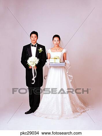 Picture - marriage, man and woman, men and women, male and female, Oriental, two people, two guys. Fotosearch