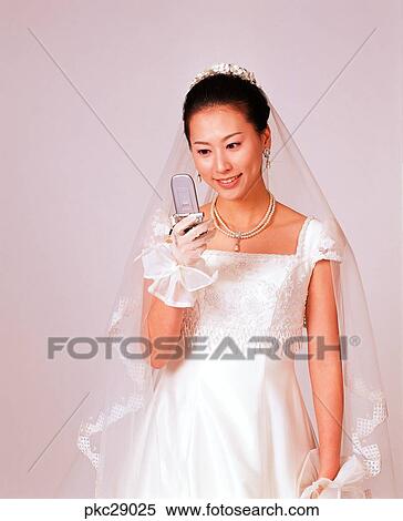Stock Photography - marriage, Oriental, dress, wedding veil, bridal veil, smile, person. Fotosearch