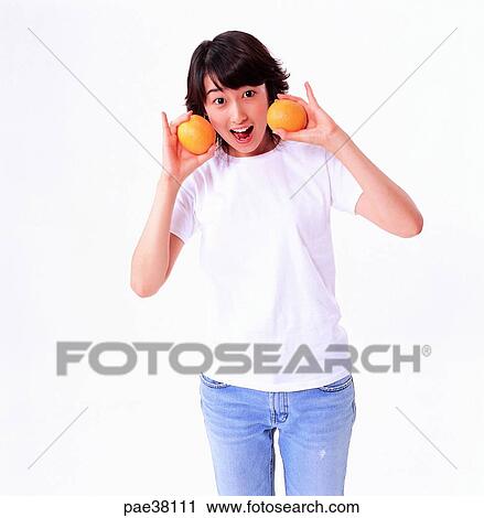 Stock Image - student, students, school girl, girl student, orange, oranges, fruit. Fotosearch
