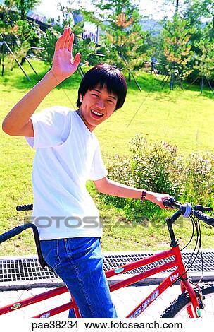 Picture - student, students, school boy, boy student, bicycle, hand, movement. Fotosearch
