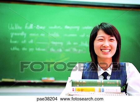 Picture - student, students, school girl, girl student, book, books, desk. Fotosearch
