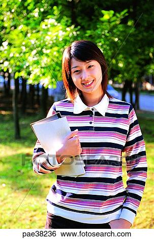 Stock Photograph - student, students, school girl, girl student, book, books, young. Fotosearch