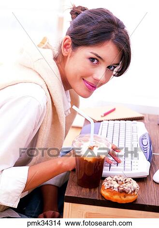 lifestyle, woman, female, keyboard, coffee, ice coffee, takeout coffee View Large Photo Image Picture - lifestyle, woman, female, keyboard, coffee, ice coffee, takeout coffee. Fotosearch