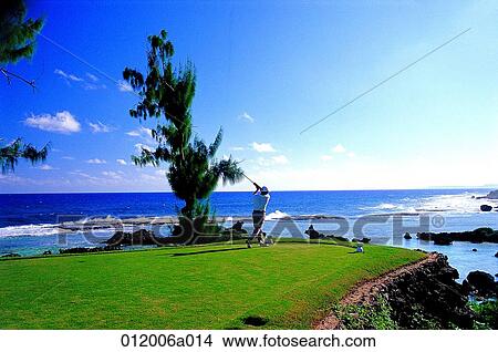 Picture - person, golf field, sea, sea, sky, waves, golf pose. Fotosearch