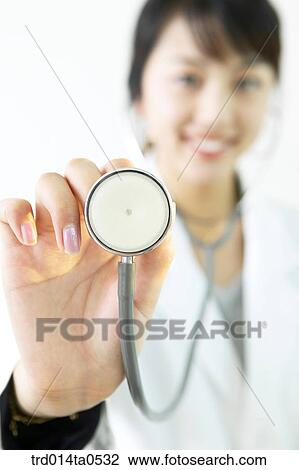 Stock Image - person, medical treatment, medicine, doctor, woman, Korean, stethoscope. Fotosearch