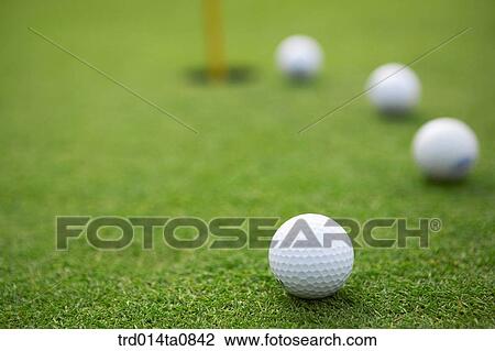 Stock Image - golf, field, golf ball, lawn grass, lawn, hole, flag. Fotosearch