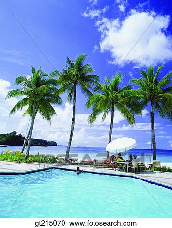 Stock Image - outdoor pool, tourist spot, sightseeing resort, beauty spot, palm, cloud, person. Fotosearch