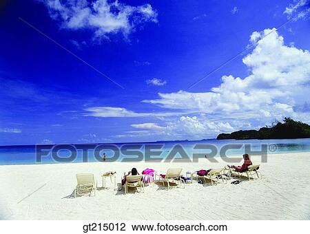 Stock Image - sea, sandy beach, beach, suntan, sunbath, sunbathing, sky. Fotosearch