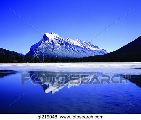 Stock Photo - mountain, lake, remaining snow, snowscape, snow, mountaintop, peak. Fotosearch
