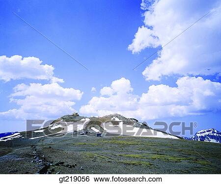 Stock Photograph - mountain, sky, cloud, clouds, snow, grassland, plants. Fotosearch