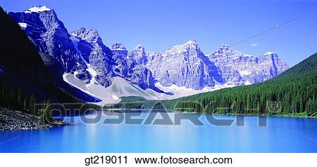 Stock Image - wintermountain, snowscape, snow, remaining snow, forest, trees, lake. Fotosearch