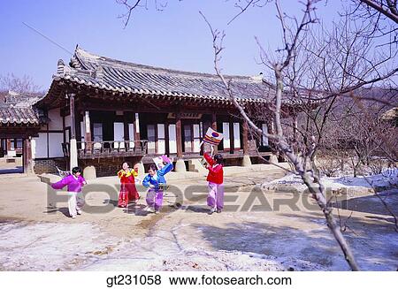 Stock Photo - flying a kite, kite, child, children, kidKorean clothes, Korean dress, winter. Fotosearch
