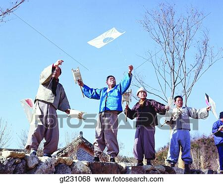 Stock Photo - flying a kite, kite, men, male, Korean clothes. Fotosearch