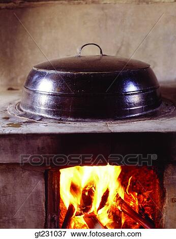 Stock Photo - kitchen, cauldron, fireplacekitchen range, firewood, fire, interior, day. Fotosearch