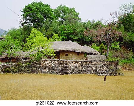 Stock Image - Nakan flok town, folk, tree, stone wall, cottage, forest, trees. Fotosearch