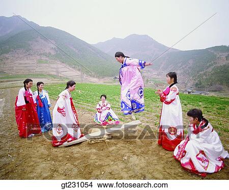 Picture - seesaw, seesawing, teetertotter, Korean clothes, Korean dress, province, country. Fotosearch