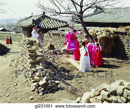 Stock Image - seesaw, seesawing, teetertotter, Korean clothes, Korean dress, province, country. Fotosearch